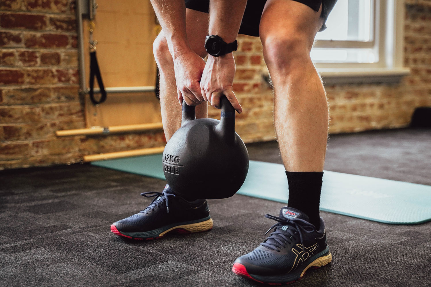 Person lifting kettlebell